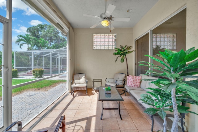 sunroom with a ceiling fan and an outdoor hangout area