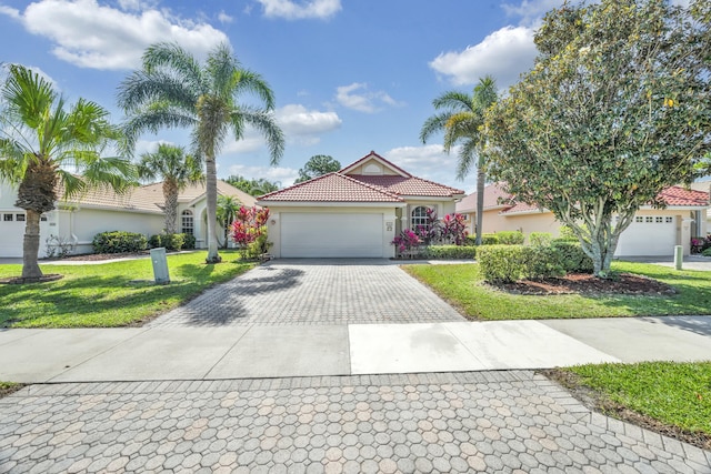 view of front of home featuring a front lawn, a residential view, stucco siding, driveway, and a garage
