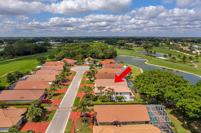 birds eye view of property featuring golf course view and a water view
