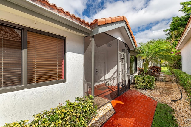 view of property exterior with a tile roof and stucco siding