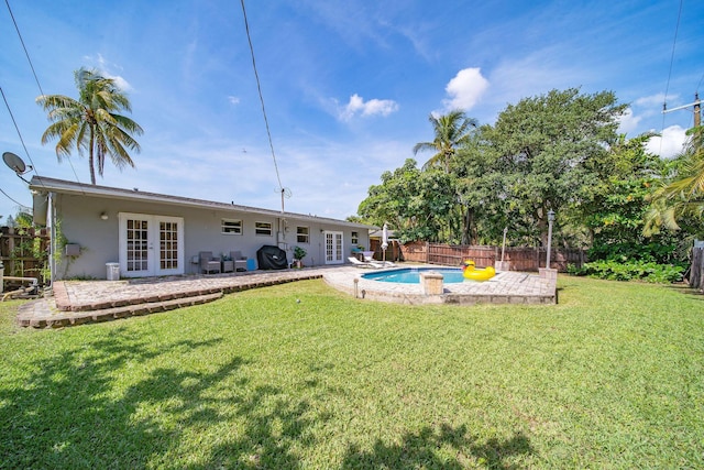 941 NW 26th Ct, Wilton Manors, FL 33311 - view of yard featuring a fenced in pool, french doors, a patio area, and a fenced backyard