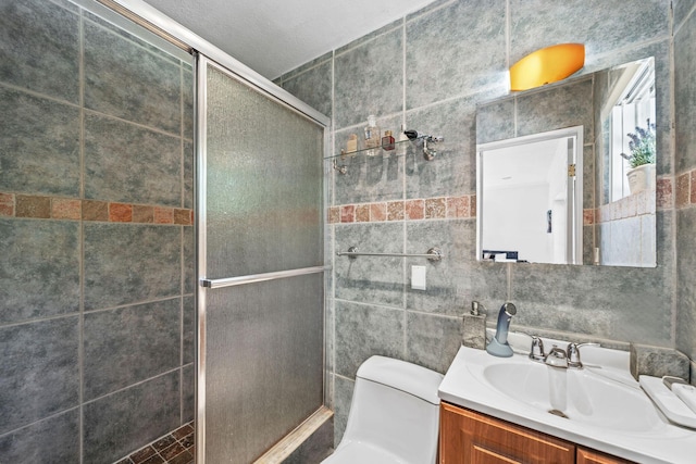 941 NW 26th Ct, Wilton Manors, FL 33311 - bathroom featuring tile walls, toilet, a stall shower, and vanity