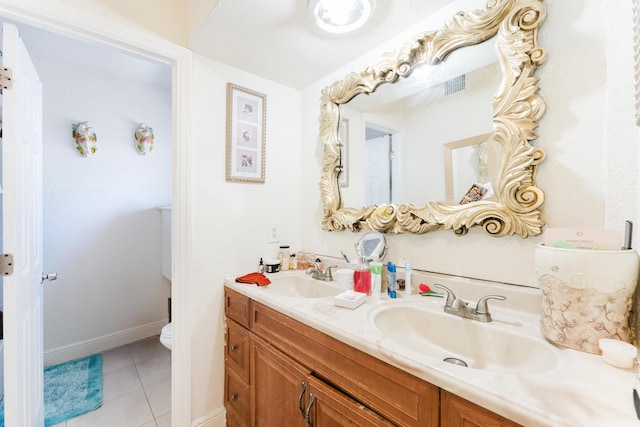 1285 NE 154th St, North Miami Beach, FL 33162 - bathroom featuring double vanity, toilet, tile patterned floors, and baseboards
