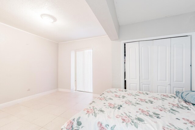 1285 NE 154th St, North Miami Beach, FL 33162 - bedroom with baseboards, a closet, and light tile patterned flooring
