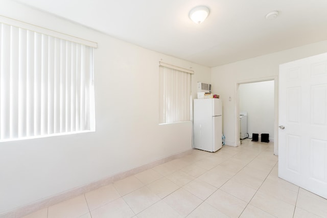 1285 NE 154th St, North Miami Beach, FL 33162 - empty room featuring a smoke detector, washer / clothes dryer, light tile patterned floors, and baseboards
