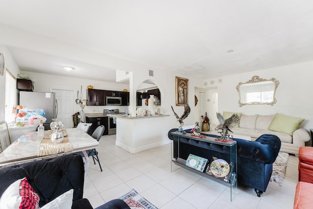 1285 NE 154th St, North Miami Beach, FL 33162 - living room featuring arched walkways and light tile patterned floors