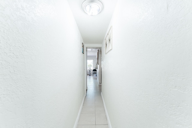 1285 NE 154th St, North Miami Beach, FL 33162 - hall featuring light tile patterned flooring, baseboards, and a textured wall