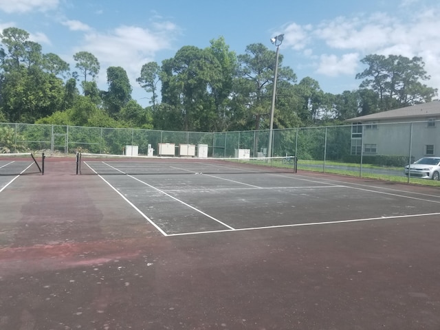7 Lake Vista Trl Unit 204, Port Saint Lucie, FL 34952 - view of tennis court with community basketball court and view of scattered trees