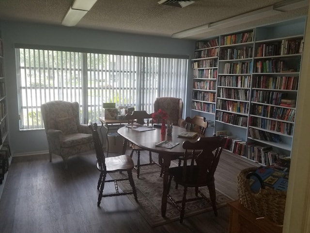 7 Lake Vista Trl Unit 204, Port Saint Lucie, FL 34952 - dining space featuring wood finished floors, a textured ceiling, and baseboards