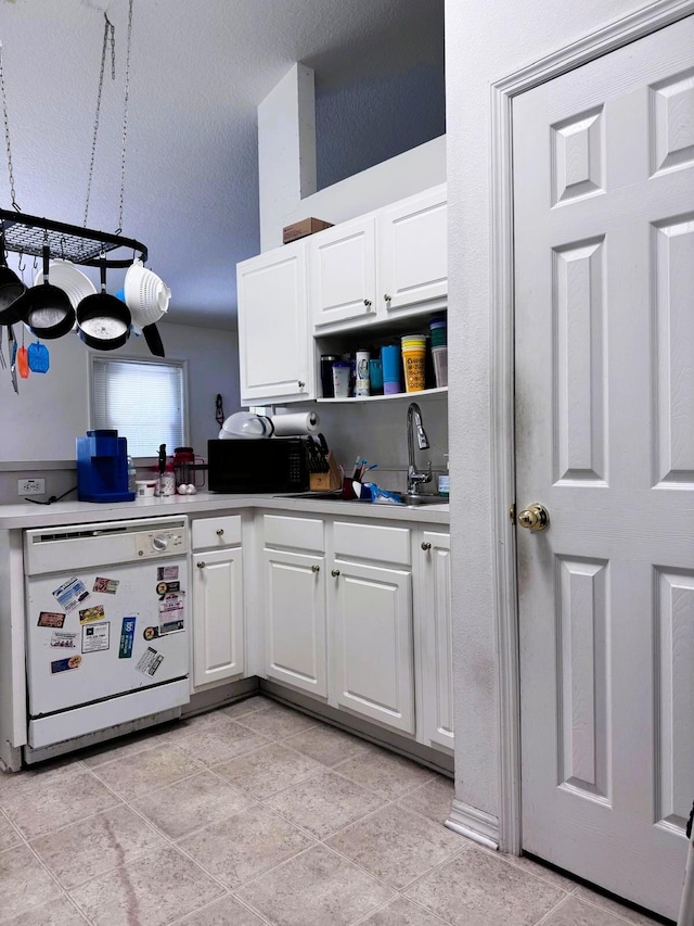 5155 NW N Macedo Blvd, Port Saint Lucie, FL 34983 - kitchen featuring white dishwasher, black microwave, white cabinets, and open shelves