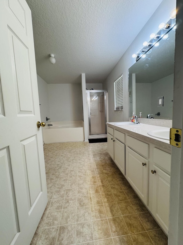 5155 NW N Macedo Blvd, Port Saint Lucie, FL 34983 - full bath featuring a shower stall, a textured ceiling, double vanity, a bath, and tile patterned flooring
