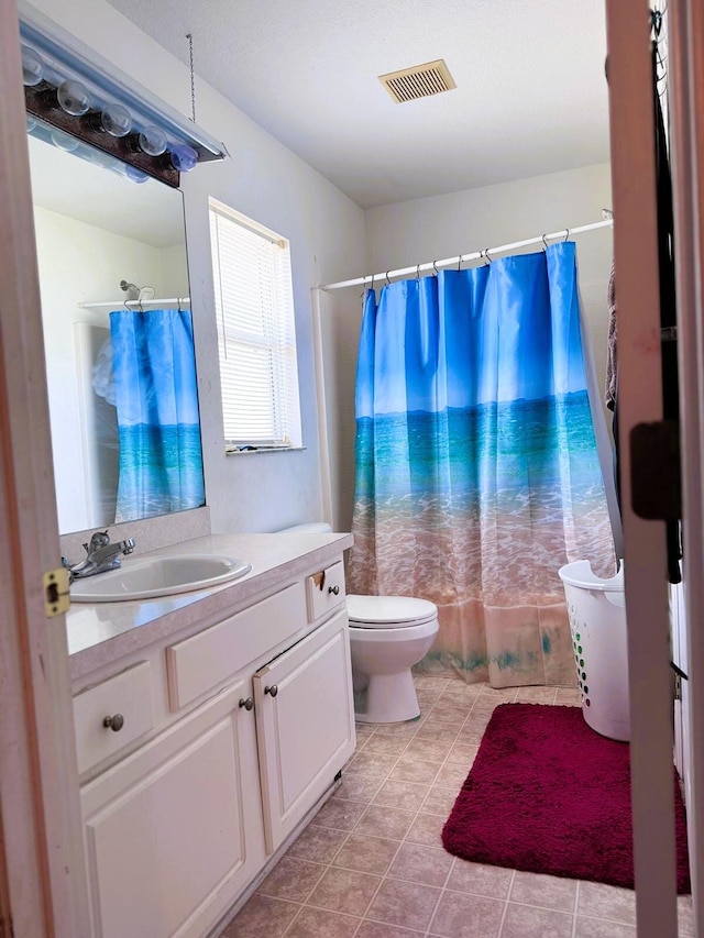5155 NW N Macedo Blvd, Port Saint Lucie, FL 34983 - bathroom with tile patterned flooring, toilet, vanity, and a shower with shower curtain