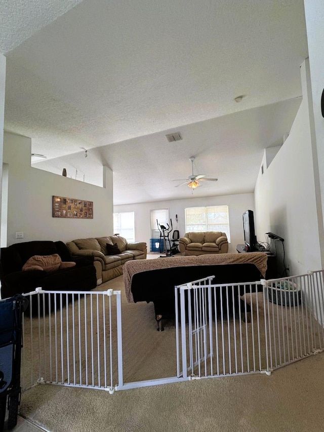 5155 NW N Macedo Blvd, Port Saint Lucie, FL 34983 - living area with carpet floors, ceiling fan, and vaulted ceiling