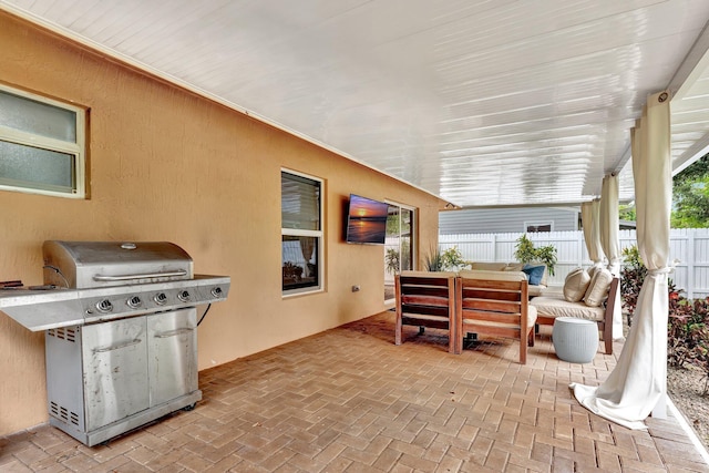 view of patio with grilling area, fence, and an outdoor hangout area