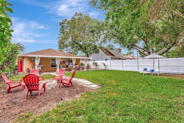 view of yard featuring an outdoor fire pit, a fenced backyard, and a patio area