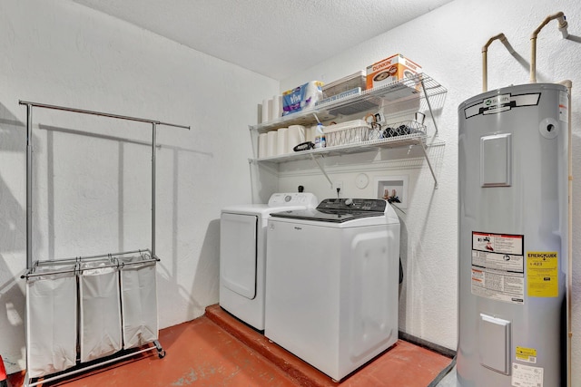 washroom featuring electric water heater, a textured wall, a textured ceiling, laundry area, and washer and clothes dryer