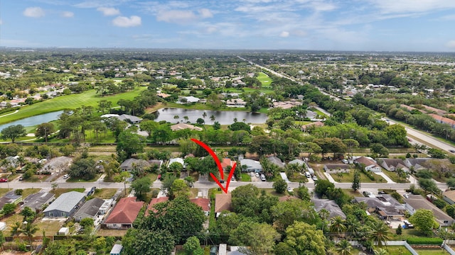 drone / aerial view featuring a water view and a residential view