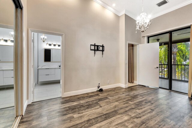 5439 Verona Dr Unit P, Boynton Beach, FL 33437 - unfurnished room featuring a chandelier, ornamental molding, baseboards, wood finished floors, and a towering ceiling