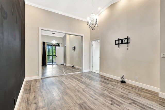 5439 Verona Dr Unit P, Boynton Beach, FL 33437 - unfurnished dining area featuring a chandelier, crown molding, wood finished floors, and baseboards