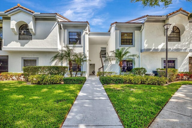 5439 Verona Dr Unit P, Boynton Beach, FL 33437 - mediterranean / spanish-style house with stucco siding, a front lawn, and a tiled roof