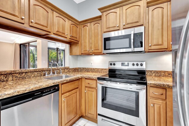 5439 Verona Dr Unit P, Boynton Beach, FL 33437 - kitchen featuring appliances with stainless steel finishes, a sink, ornamental molding, light stone counters, and light tile patterned floors