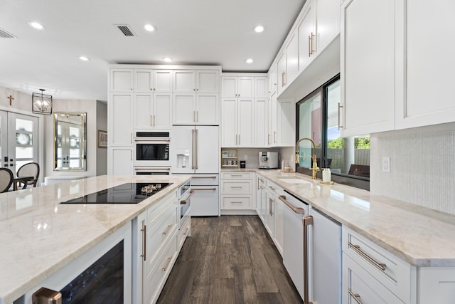 1784 SW Erie St, Port Saint Lucie, FL 34953 - kitchen with white appliances, dark wood-type flooring, visible vents, wine cooler, and a sink