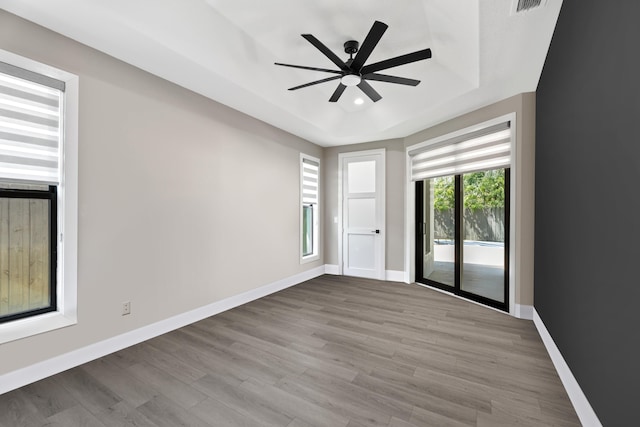 1784 SW Erie St, Port Saint Lucie, FL 34953 - unfurnished room with baseboards, recessed lighting, wood finished floors, a raised ceiling, and ceiling fan