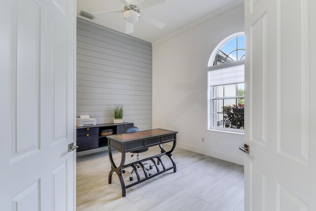 office space with ceiling fan, light wood-style flooring, visible vents, wooden walls, and baseboards