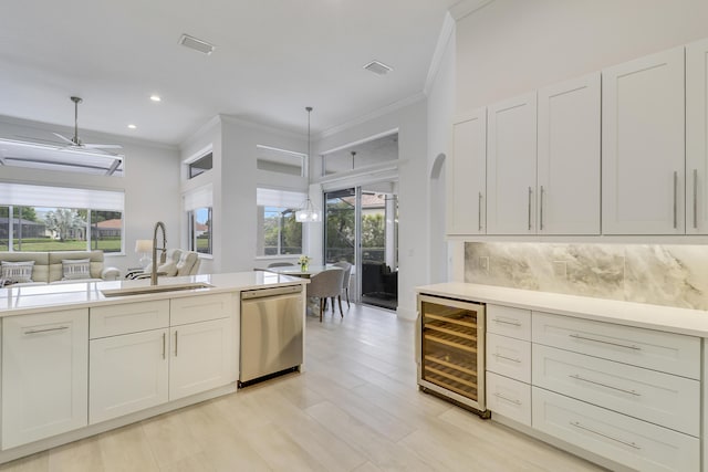 kitchen featuring visible vents, a sink, wine cooler, backsplash, and stainless steel dishwasher