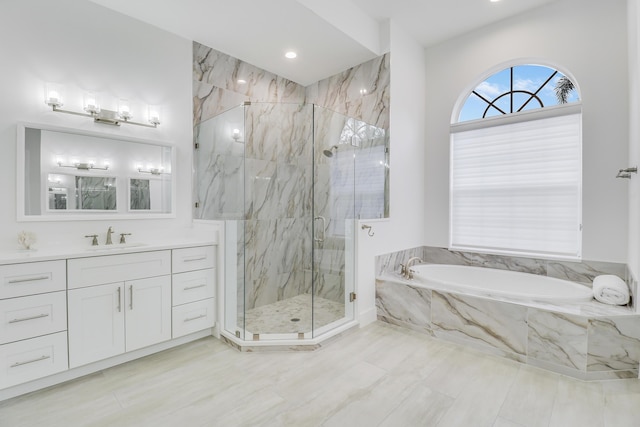 full bathroom with a bath, a marble finish shower, and vanity
