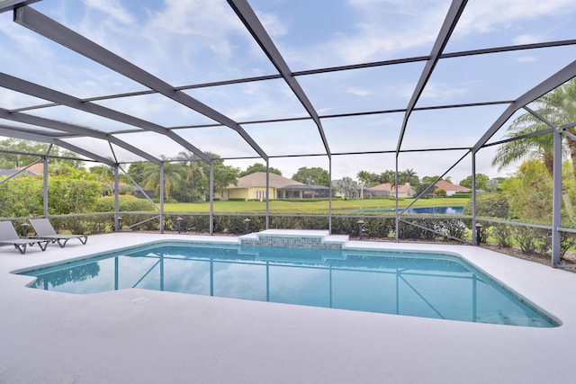 outdoor pool with a water view, a patio, and a lanai