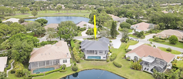 drone / aerial view with a water view and a residential view