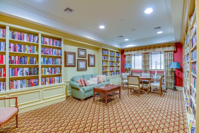 sitting room featuring ornamental molding, recessed lighting, carpet floors, visible vents, and built in shelves