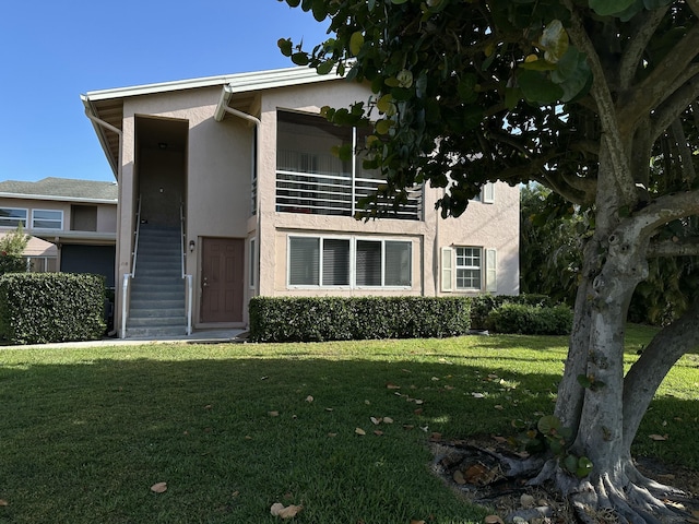 12394 Alternate A1A O7, Palm Beach Gardens, FL 33410 - view of front of home with a front yard and stucco siding