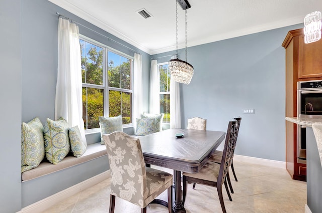 dining space with visible vents, baseboards, ornamental molding, a chandelier, and light tile patterned flooring