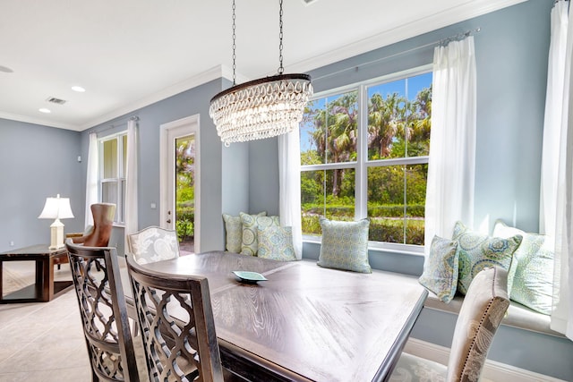 dining room featuring ornamental molding, baseboards, plenty of natural light, and a notable chandelier