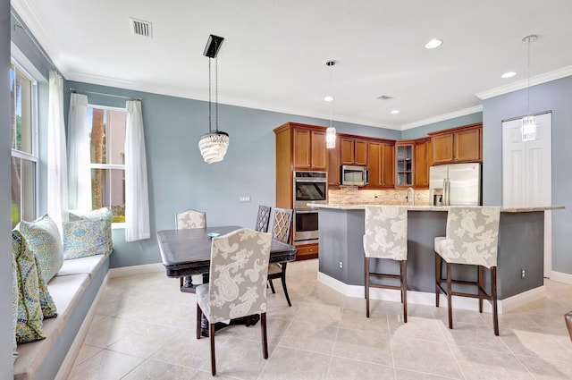 kitchen featuring tasteful backsplash, visible vents, glass insert cabinets, brown cabinetry, and stainless steel appliances