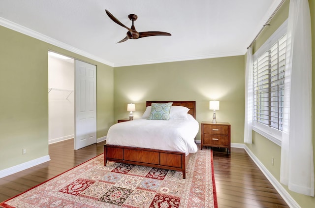 bedroom with crown molding, baseboards, ceiling fan, and wood finished floors