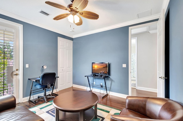living area featuring visible vents, baseboards, a ceiling fan, and wood finished floors