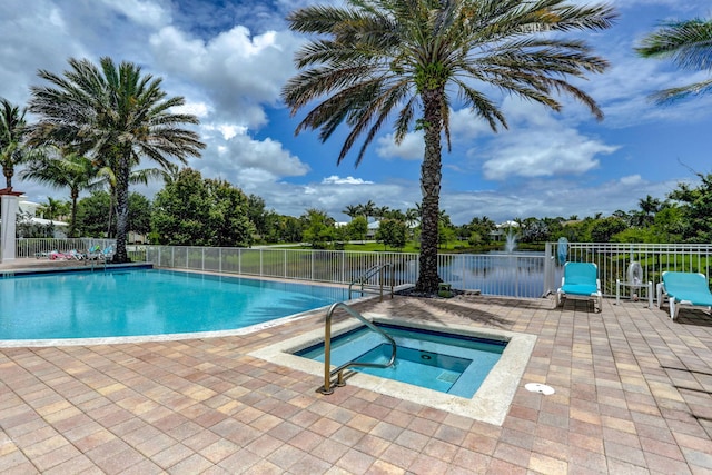 community pool with a community hot tub, fence, and a patio