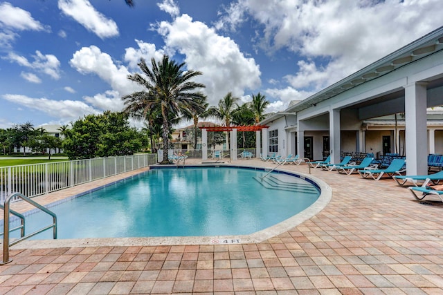 community pool featuring a patio area and fence