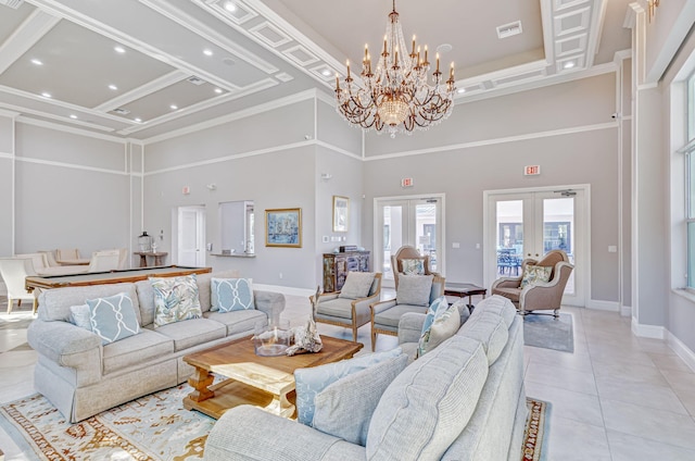 living area featuring visible vents, baseboards, an inviting chandelier, a towering ceiling, and light tile patterned flooring