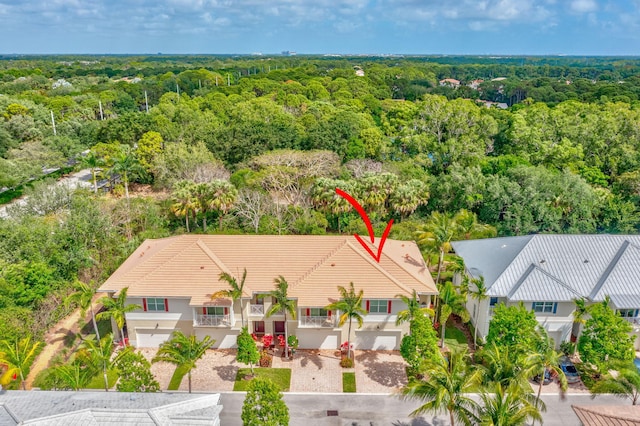 birds eye view of property with a wooded view