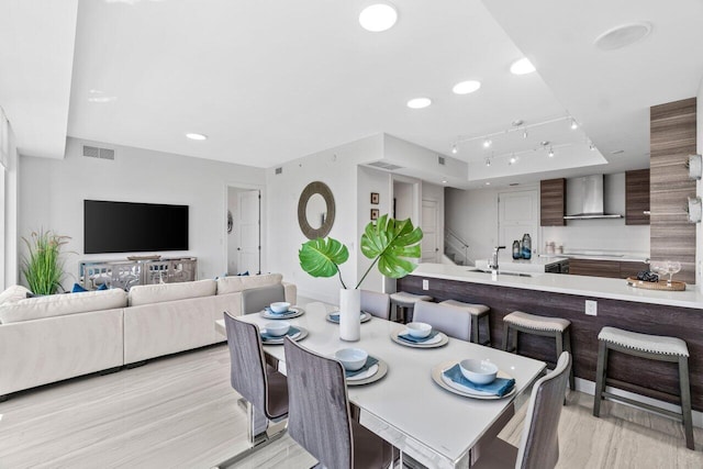 dining area featuring light wood finished floors, visible vents, and recessed lighting