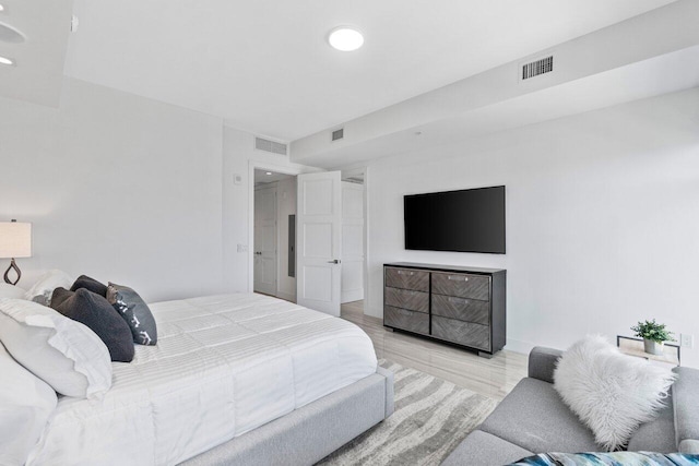 bedroom featuring recessed lighting, wood finished floors, and visible vents