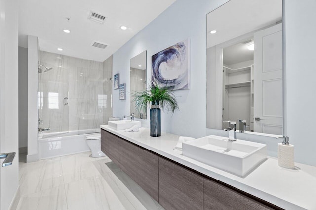 bathroom with marble finish floor, enclosed tub / shower combo, visible vents, toilet, and a sink