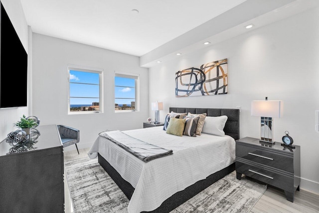 bedroom with light wood finished floors, baseboards, and recessed lighting