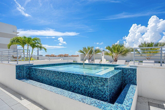 view of pool featuring a fenced in pool and a hot tub