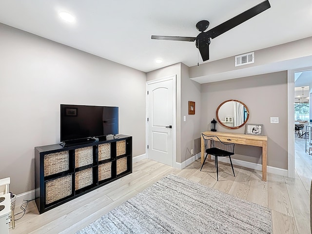 office space featuring visible vents, baseboards, ceiling fan, and wood finished floors