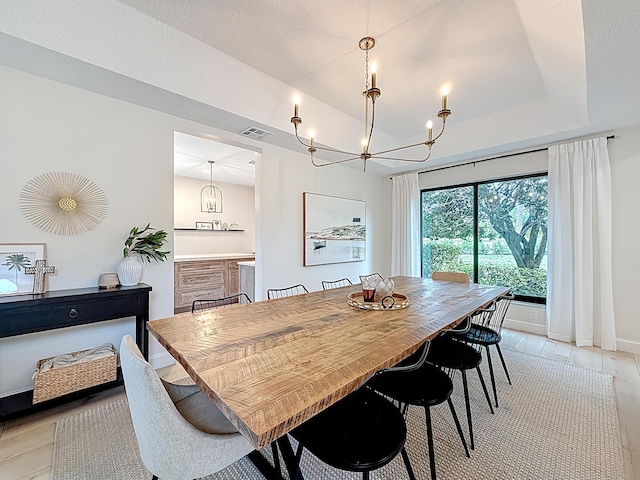 dining area featuring an inviting chandelier, baseboards, and visible vents